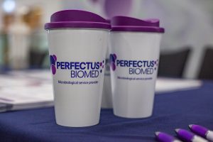 Perfectus Biomed takeaway mugs at a conference